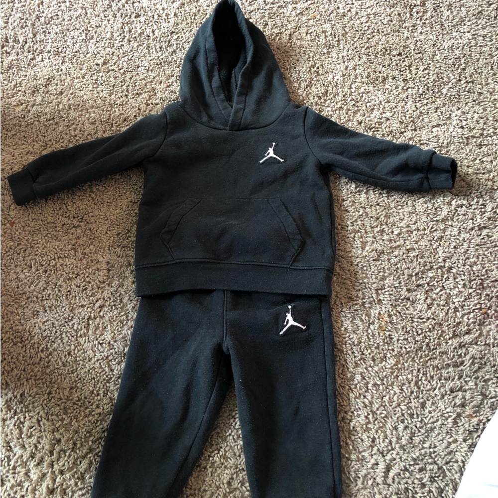 A handful of baby clothes, ranging from 12M to 18M